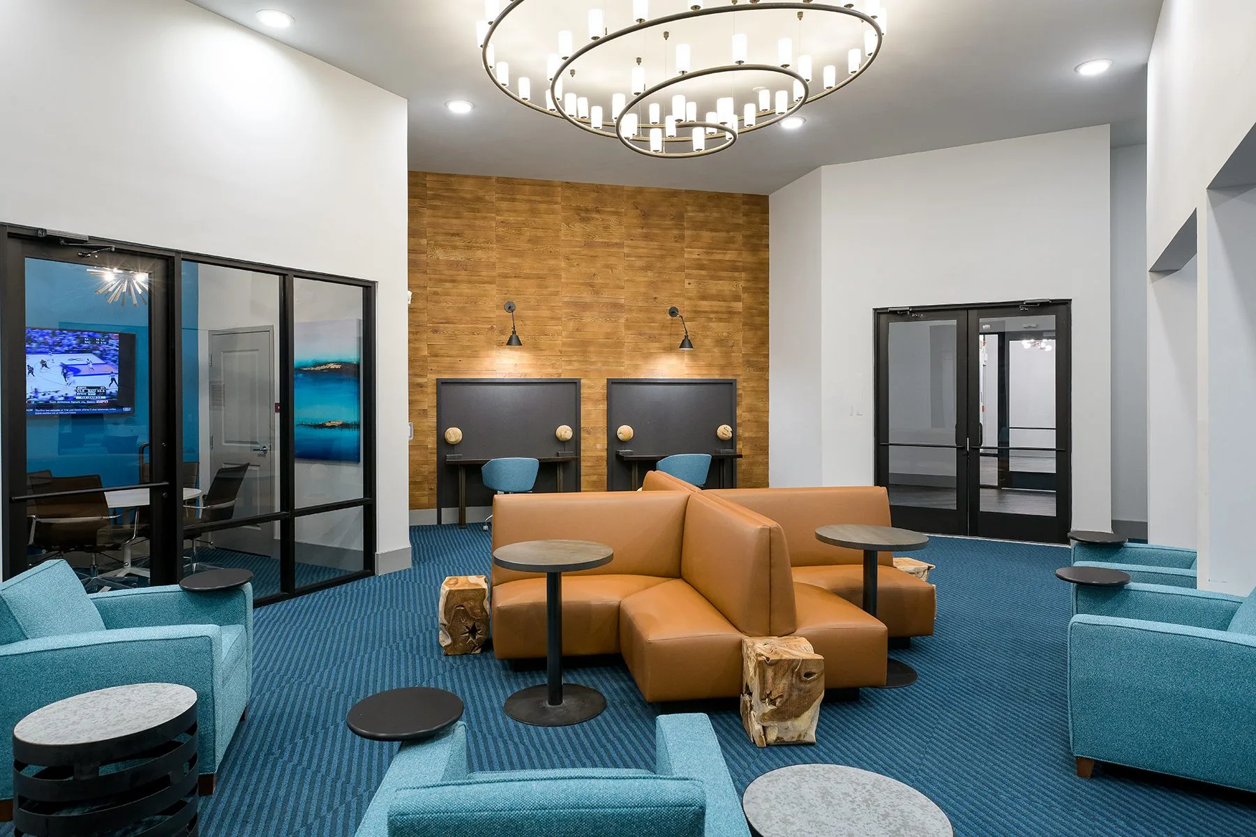Reference photo of a fraternity-grade common lounge with leather seating and feature lighting